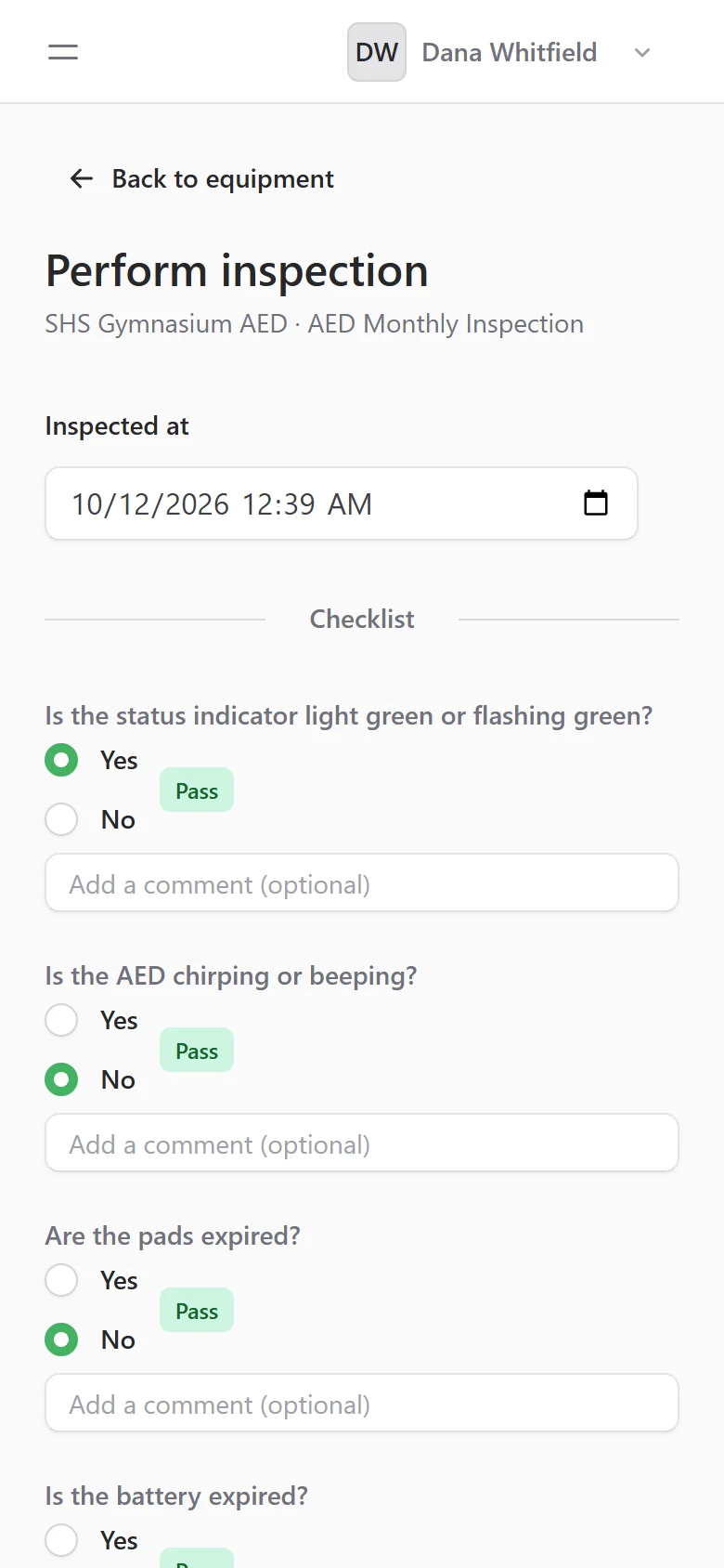 A monthly AED inspection on a phone in AED Log, with each answered checklist question marked Pass