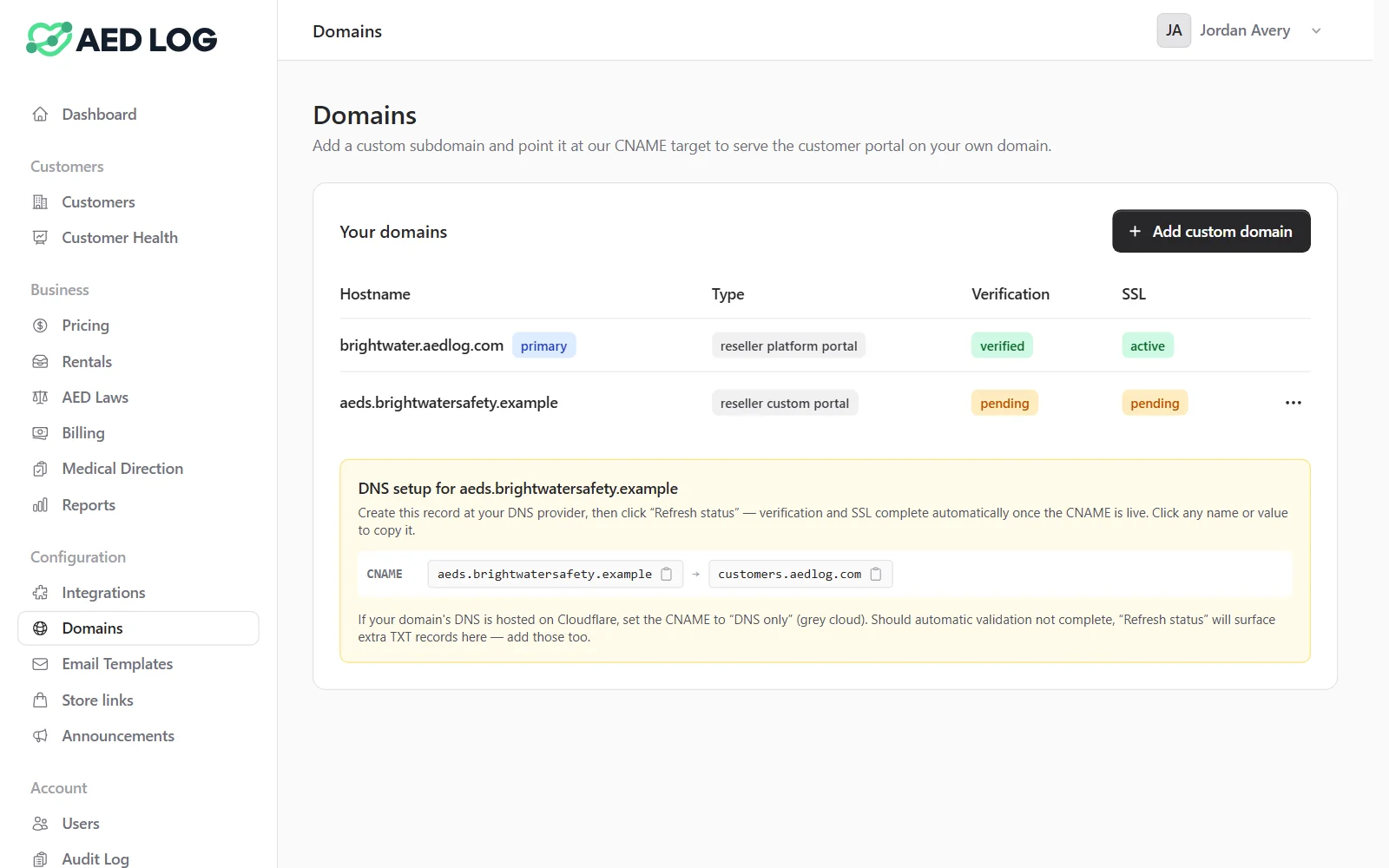 The Domains page of a reseller console: the default portal address and the custom domain aeds.brightwatersafety.example waiting for verification, with the one CNAME record to add at the DNS provider