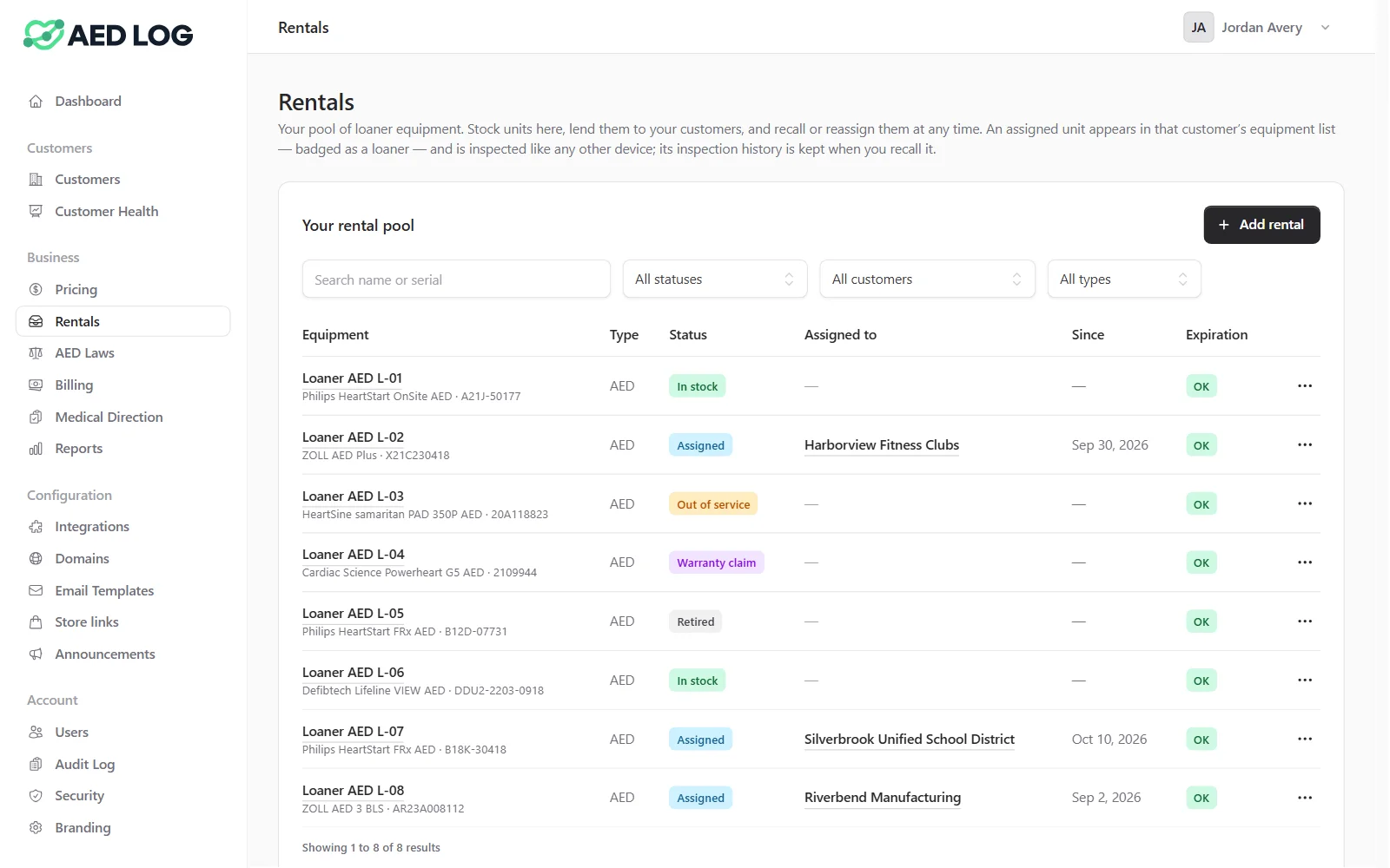 The Rentals page of a reseller console: eight loaner AEDs with their model and serial number, status (in stock, assigned, out of service, warranty claim or retired), and the customer each assigned unit is lent to and since when